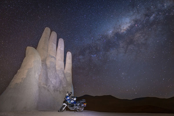 Photo by David Denis (Belgium) - Antofagasta Region, Chile - "La Mano del Desierto" under the Milky Way - 2015-2016 Trans-American adventure - 1997 Honda Africa Twin. www.daviddenis.be.