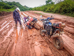 Photo by George Guille (New Zealand) of Tommy Elvis battling through a very muddy road indeed near Sucre, Bolivia. Africa Twin and BMW HP2.