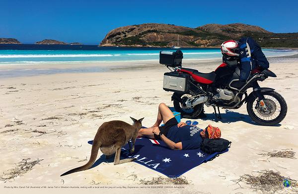 Photo by Mrs. Candi Toll (Australia) of Mr. Jamie Toll in Western Australia, resting with a local and her joey at Lucky Bay, Esperance, next to his 2008 BMW 1200GS Adventure.