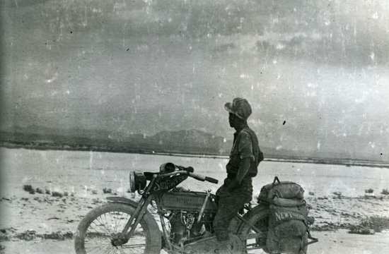 Mack Laing on bike looking into the distance, 1915.