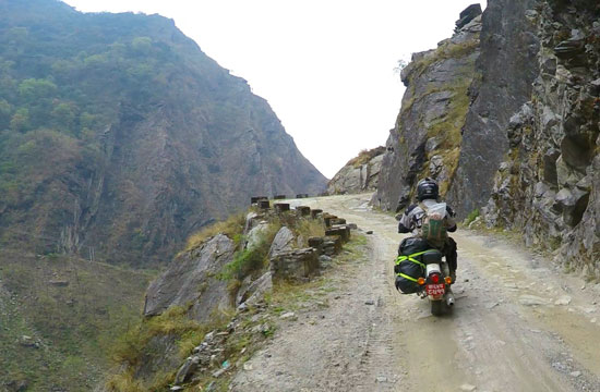 Michelle riding cliffside road in Nepal