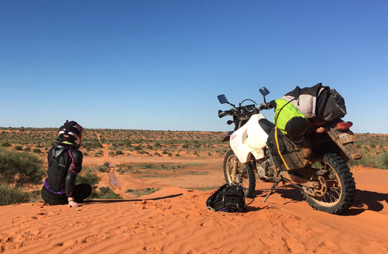 Sarah Taylor and bike in the desert.