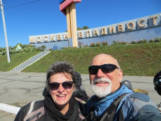 Shirley and Brian Hardy-Rix in front of Moscow to Vladivostok sign.