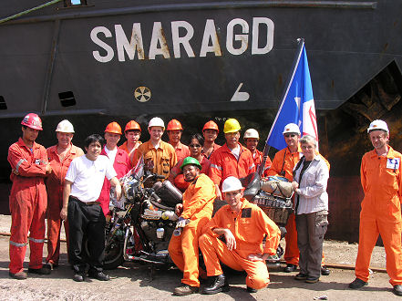 Group photo of the crew, ship and bike