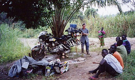 Locals assisted by cutting down a tree to lift the bike, bowl to wash off the mud