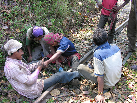 Repairing the track. Drilling holes by hand