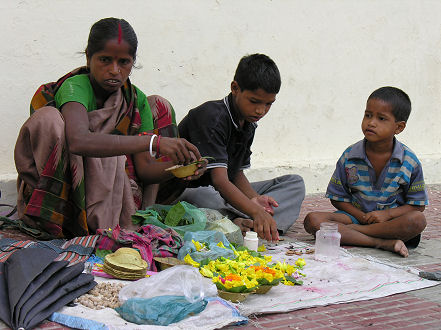 Preparing floating flower bowls for Ganges offerings