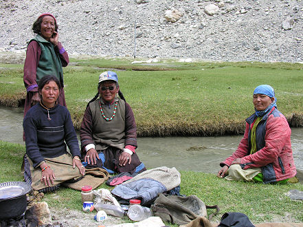 Nomadic women cooking over a yak dung fire