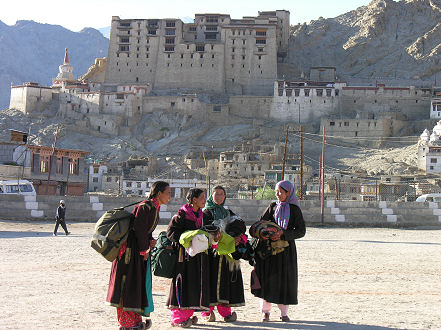 Locals gather for the festival, palace in background