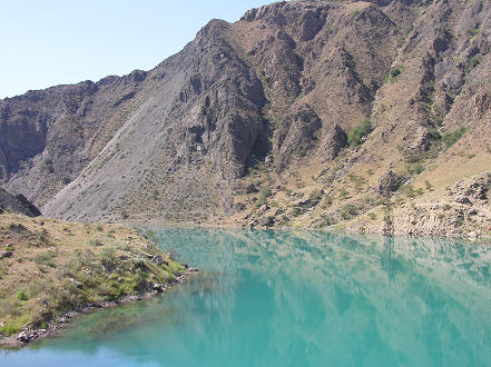 Turquoise river and barren mountains