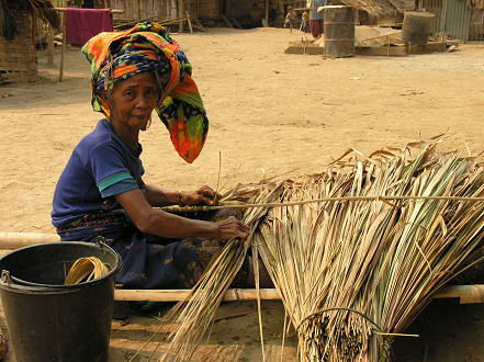 Making grass roofing for village houses