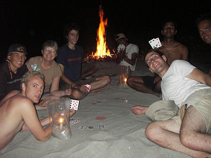 Playing cards around an evening campfire