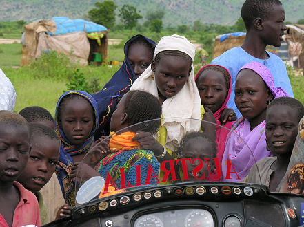 Interested children gather about the motorcycle