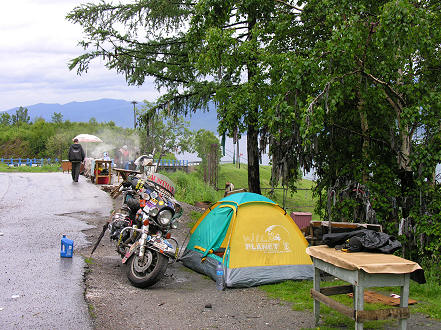 A wet morning after camping between the road and railway line with bike repairs