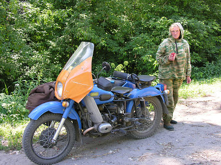 Selling wild strawberries out of the back or her Ural motorcycle 