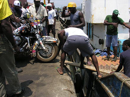 Luggage handlers preparing to load the motorcycle, damaged the front guard