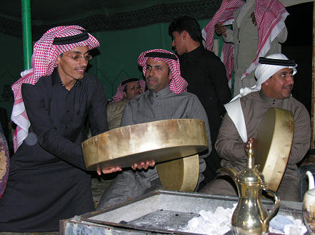 Warming the camel skin drums before playing