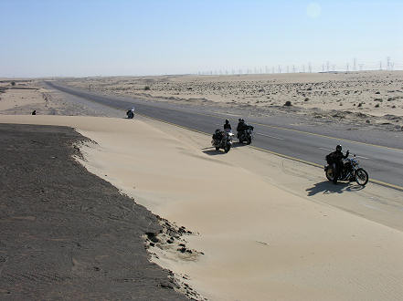 Asphalt sprayed to stabilize the drifting sand dunes roadside