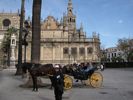 People enjoying horse carriage rides in Seville