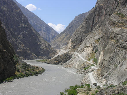 Road hugs the mountain side alongside the river