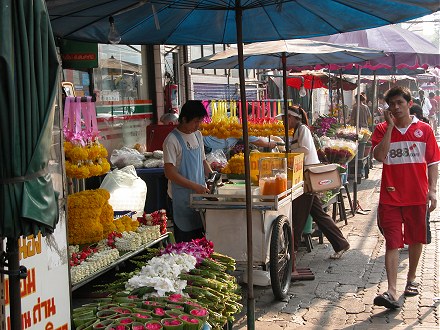 Roadside stalls of fruit juice and flower sellers in Bangkok
