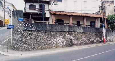 mosaic wall mural in Salvadore, Brazil showing a snake chasing a biker and his lady on a motorcycle