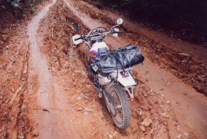 Wet Thai jungle mud is more slippery than K-Y Jelly on glass and an error in judgement found my motorcycle high-centered in a two-foot deep rut.