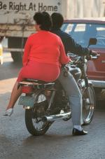 Woman on motorcycle in Guatemala City.