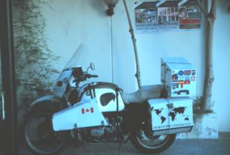 Bike in front of propaganda poster, Hotel El Kabir, Tripoli, Libya.