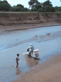 Grant crossing a river after the concrete bridge was washed away