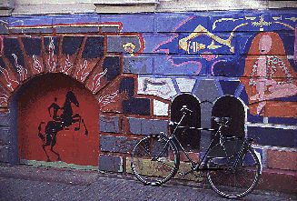 Bicycle in front of painted wall in Amsterdam.