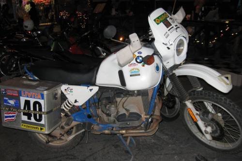 German registered R80 GS motorcycle in parking lot, travelers on the road around the world.