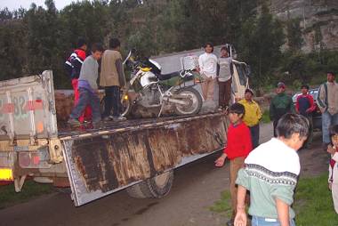 Youngsters helping unload Glen's wounded motorcycle.