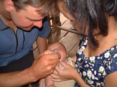 Jurgen administering polio vaccine.