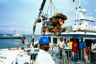 Transferring bike to boat, Congo.