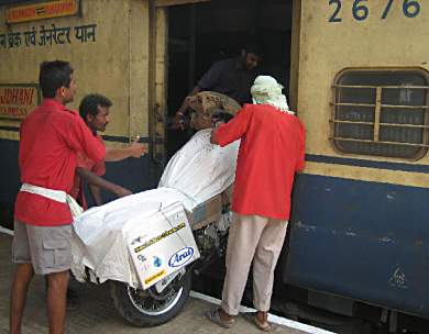 Loading bike on train, Margao, India.