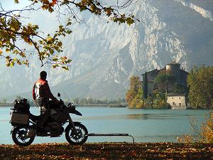 September: by Yau Chi Lim, Canada; Solo RTW. A magical lake and castle in the Dolomites near Trento, Italy, BMW R1200 GS.