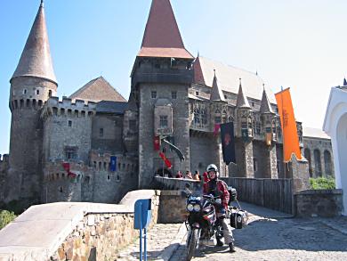 Pat in front of 12th Century Transylvanian Castle called Corinesti Castle in Hunedoara.