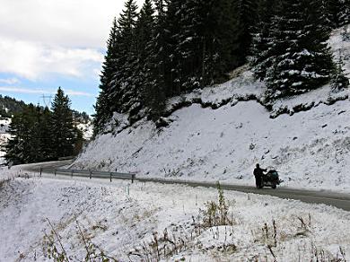 Roadside snow on the pass indicates winter approaching.