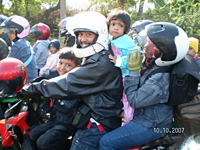 Family riding to ferry in Indonesia.