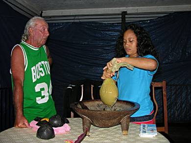 Toni and Liliosa preparing the kava for drinking.