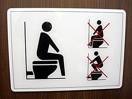 Instructions on how to use a public toilet.