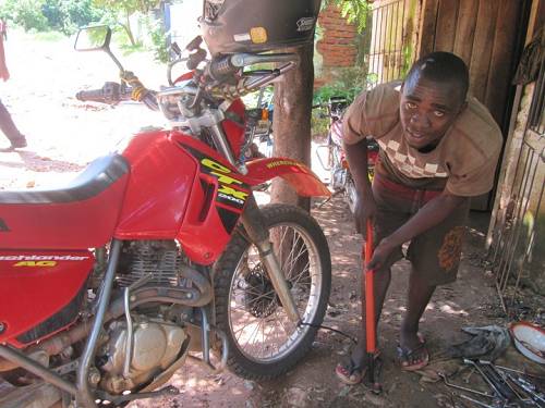 Boy with bike pump, Malawi.