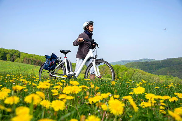 Riding Upway Electric bike in beautiful meadow