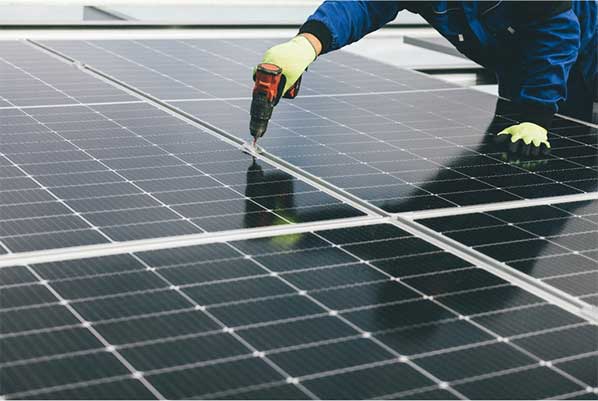 Person working installing a solar panel