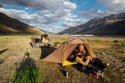 Photo by Michael Jordan (New Zealand) of himself enjoying a warm meal on a cold evening in the Zangskar Valley, Ladakh, India, during his RTW trip in 2016. 2011 KLR650 parked in the background.