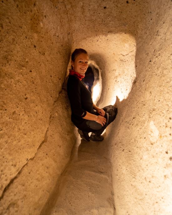Joshua Steinberg, A woman crouched in a sunny nook.