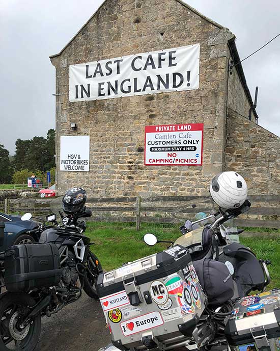 Last cafe in England with motorcycles parked in front.
