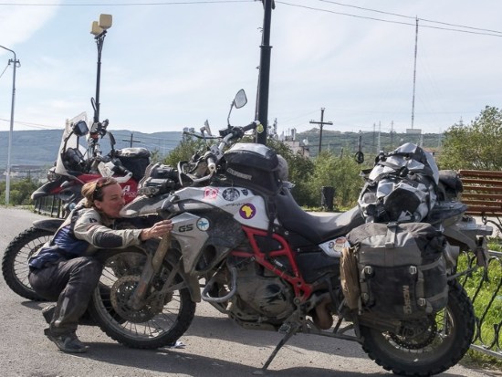 Heather Lea kisses her F800 motorcycle at the end of the Full Circle tour.