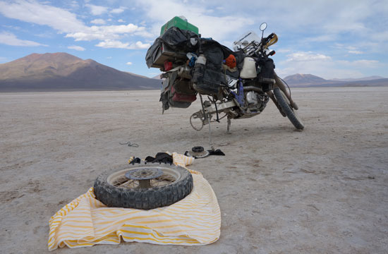 Mike and Shannon Mills fixing a tire in Bolivia.